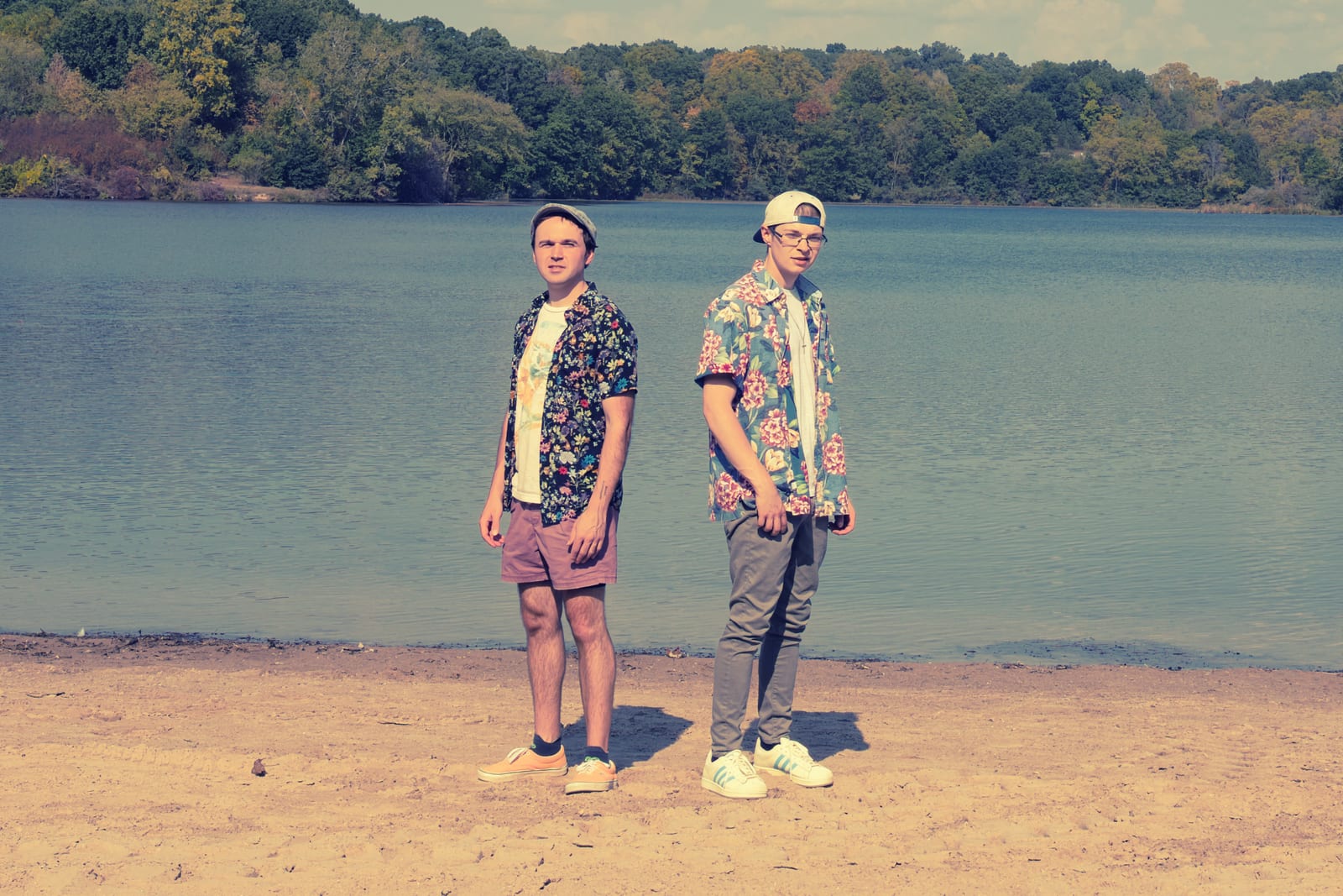 Stephen Michael and Jake Long standing back to back on a lakeshore